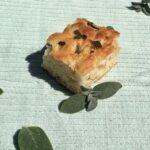 Slice of vegan brown butter and sage focaccia bread.