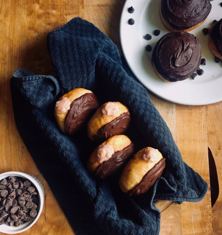 Chocolate Strawberry doughnuts. Vegan yeast donuts with chocolate icing and strawberry cream filling.