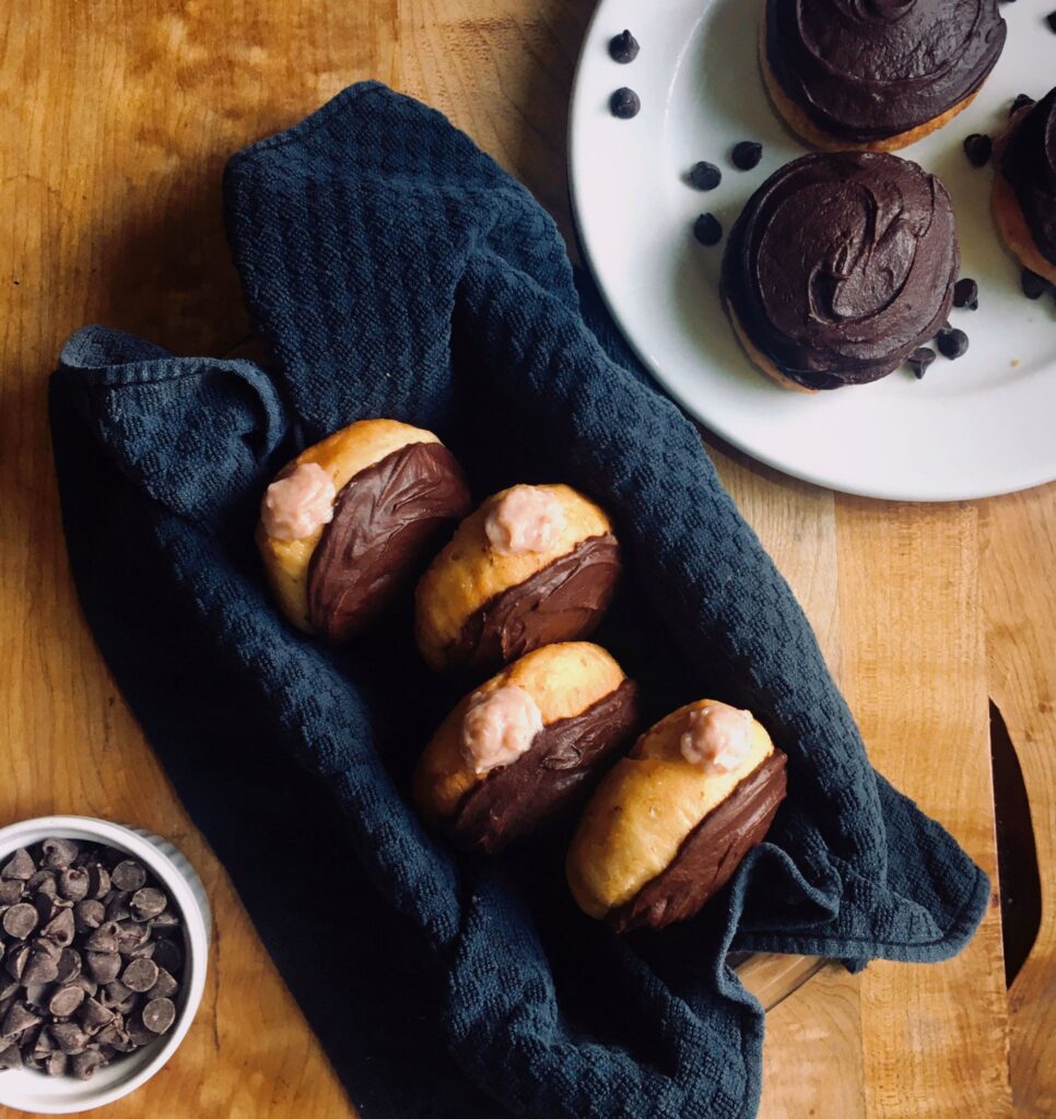 Chocolate Strawberry doughnuts. Vegan yeast donuts with chocolate icing and strawberry cream filling.