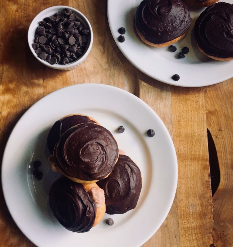 Plant-based yeast donuts with chocolate frosting and strawberry filling.