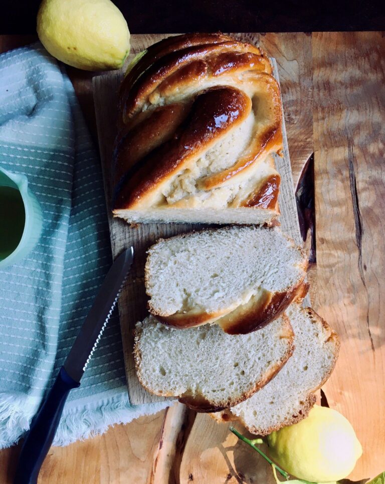 Plant-based lemon babka sliced on a cutting board.