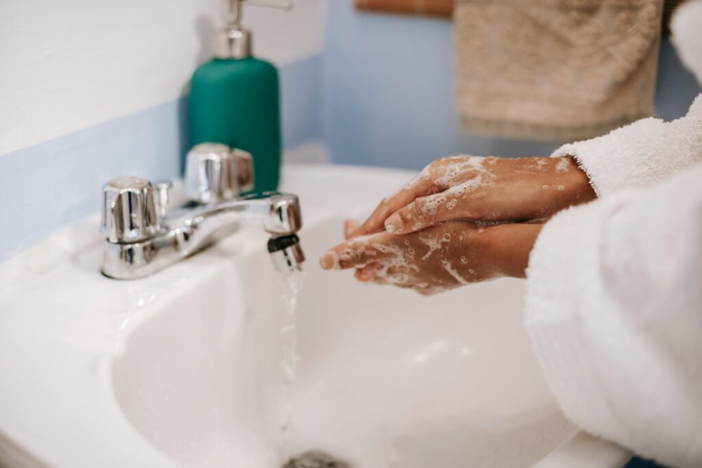 person washing hands with refillable natural soap because biodegradable products are important.