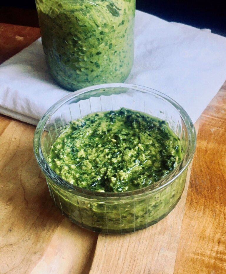 Vegan nut-free herb pesto in a jar and glass bowl.