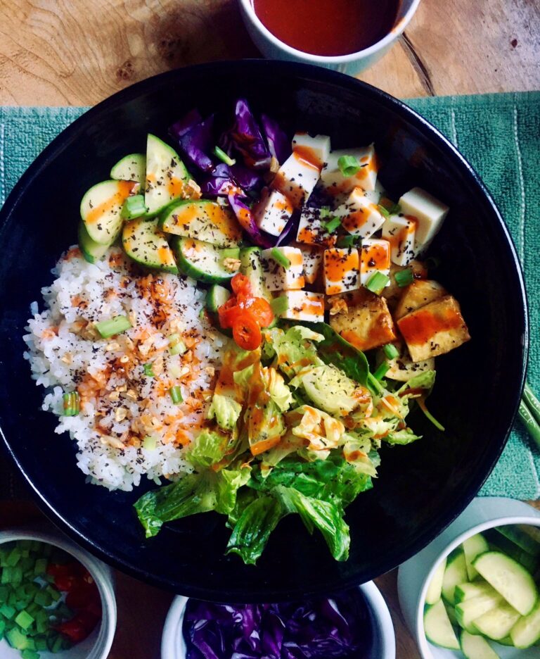 Vegan poke bowl with half lettuce and half rice.